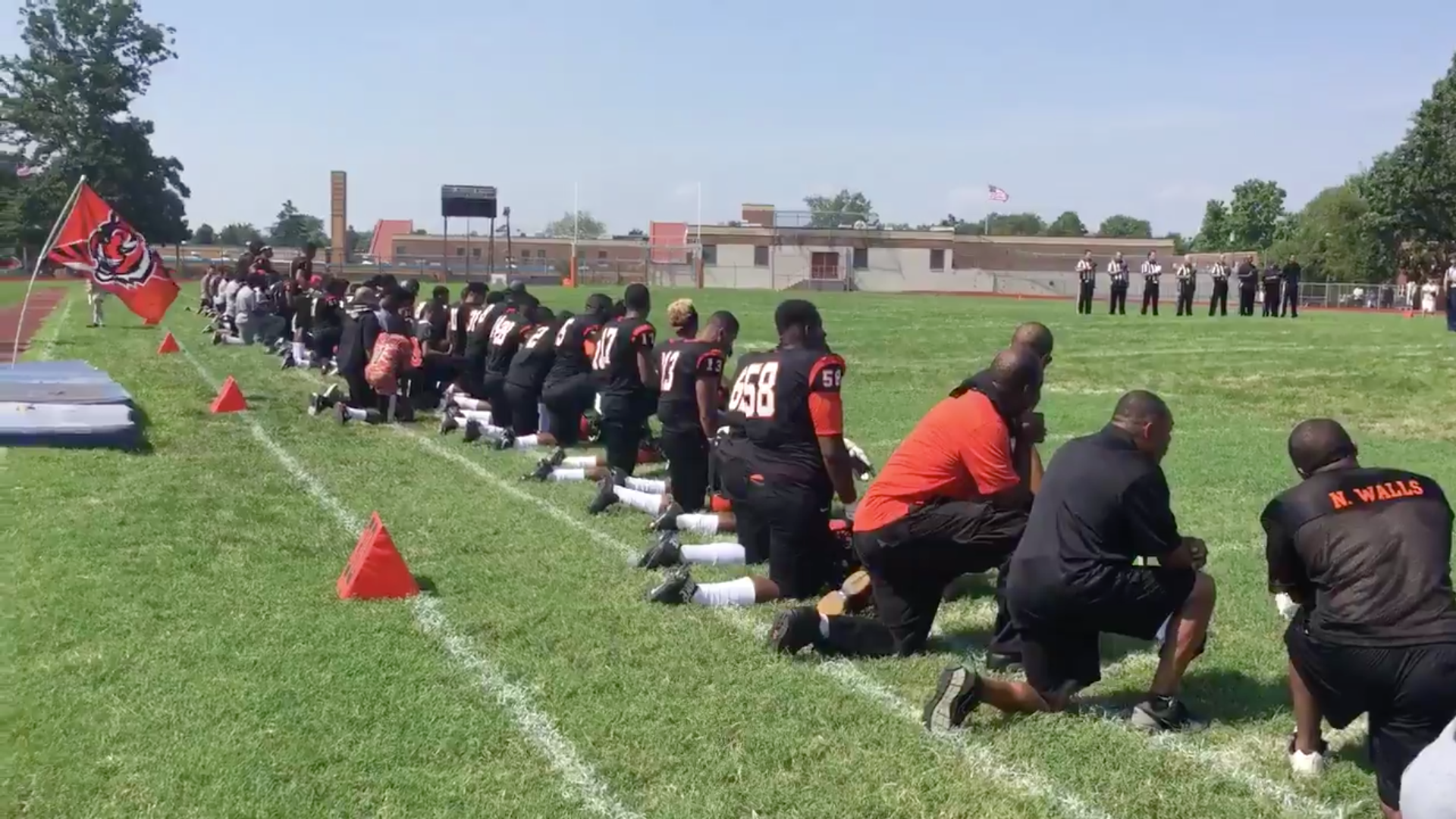High School Football Team & Coach Kneel During National Anthem 
